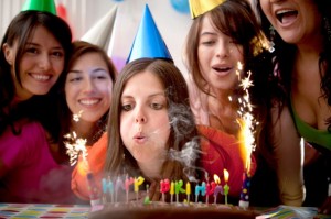 Woman blowing out birthday candles